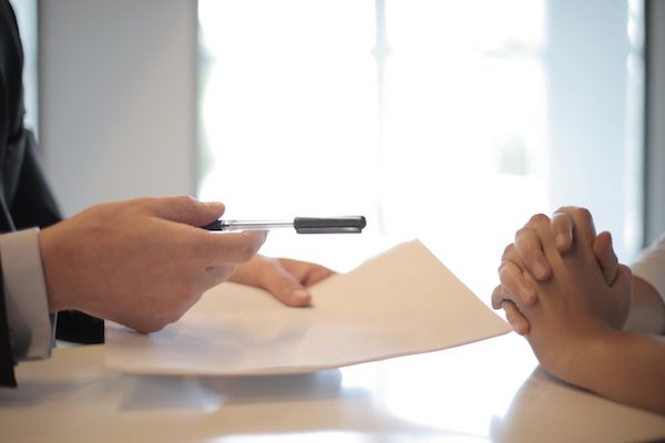 crop-businessman-giving-contract-to-woman-to-sign-3760067